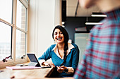 Happy, laughing businesswoman in office