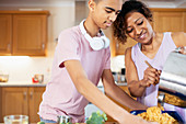 Mother and teenage son cooking