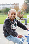Portrait girl riding bike at playground