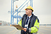 Dock manager with clipboard at shipyard