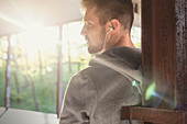 Profile male runner listening to music with headphones