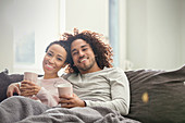 Portrait couple relaxing on sofa