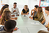 High school students talking at table in debate class