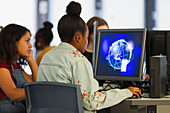 Junior high girl student using computer in computer lab