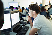 Focused boy student using computer in computer lab