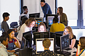 Students and teachers using computers in computer lab
