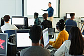 Students at computers watching teacher
