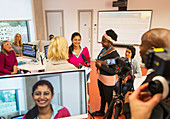 Community college students filming in media classroom