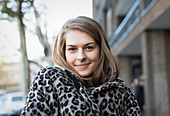 Portrait young woman in leopard print coat