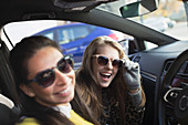 Portrait happy, playful women wearing sunglasses in car