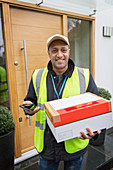 Portrait confident, friendly deliveryman at front door