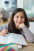 Portrait confident, girl doing homework