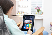 Girl using smart home automation system on digital tablet