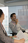 Laughing businessman in conference room meeting