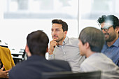 Focused businessman listening in conference room meeting