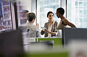 Business people with tablet talking, meeting in office