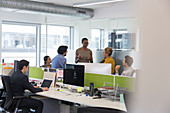 Business people talking, meeting in open plan office