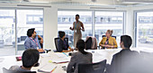 Businesswoman leading conference room meeting