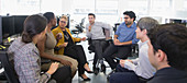 Business people talking, meeting in open plan office