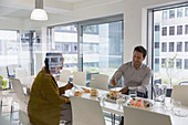 Business people eating sushi lunch in conference room
