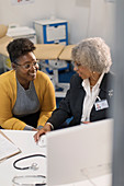 Doctor meeting with patient at computer in doctors office