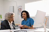 Doctor prescribing medication to senior patient