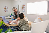 Paediatrician examining baby girl