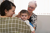 Cute baby girl being examined by paediatrician