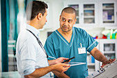 Male doctor and nurse talking in hospital