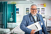Portrait senior male doctor making rounds in hospital