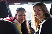 Portrait happy young women inside car