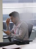 Businessman using smart phone in office