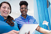 Portrait doctor and nurse using tablet in hospital room