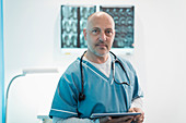 Portrait male doctor using digital tablet in hospital