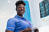 Portrait nurse with tablet examining x-rays