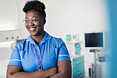 Portrait confident, female nurse in in hospital room