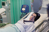 Female patient resting in hospital bed