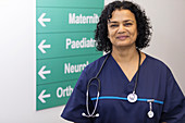 Portrait female doctor in hospital corridor