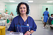 Portrait female doctor making rounds in hospital ward