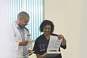 Doctors with medical chart consulting in hospital