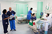 Doctors, nurse and patient in hospital ward