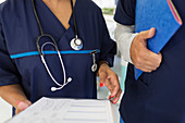 Close up doctors with medical chart consulting in hospital