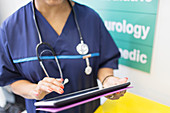 Female doctor using digital tablet in hospital