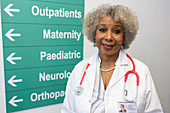 Portrait senior female doctor in hospital corridor