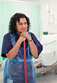 Thoughtful female orderly cleaning hospital ward