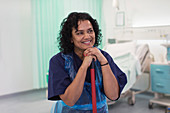Smiling female orderly cleaning hospital ward