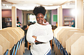 Portrait young female college student in library