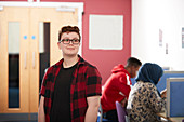 Portrait ambitious young male college student in library