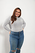 Portrait young woman in sweater and jeans
