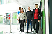 College students walking in sunny corridor